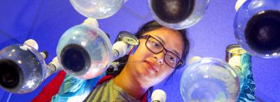 University of Louisiana at Lafayette student stands over scientific instruments